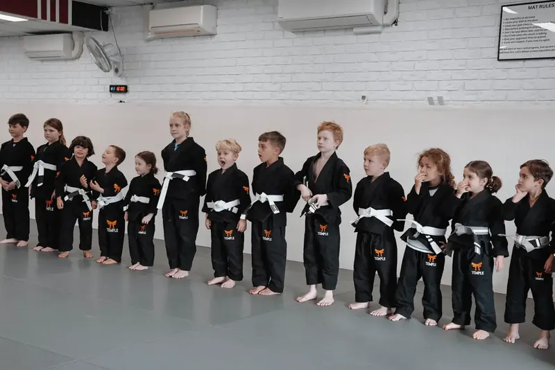 Kids in gis lined up for class at Temple BJJ